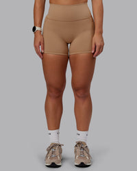 Woman wearing Fusion Ultra High-Rise 4" Short Pockets - Warm Smoke | Set:true | Angle:front | Model:Lyss | Size:S