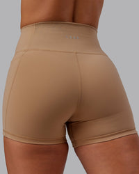 Woman wearing Fusion Ultra High-Rise 4" Short Pockets - Warm Smoke | Model:Lyss | Size:S