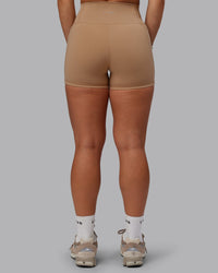 Woman wearing Fusion Ultra High-Rise 4" Short Pockets - Warm Smoke | Set:true | Angle:back | Model:Lyss | Size:S