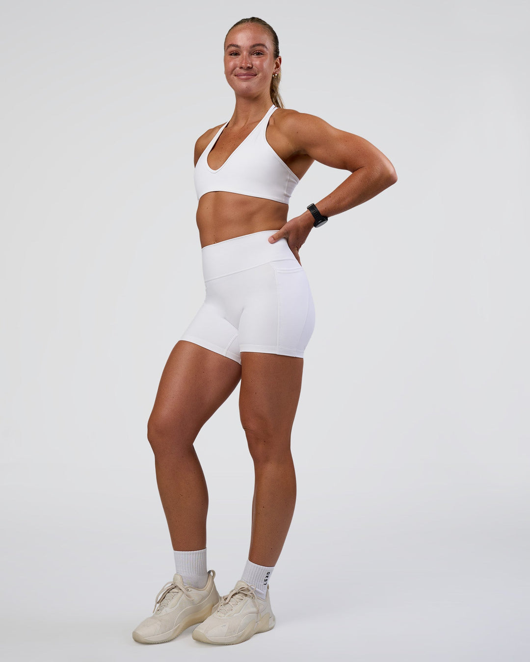 Woman wearing Fusion Ultra High-Rise 4" Short Pockets - White | Model:Sav | Size:S