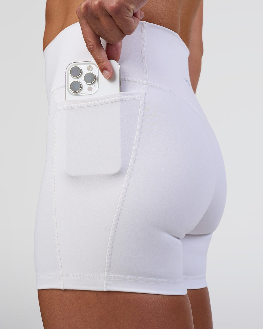 Woman wearing Fusion Ultra High-Rise 4" Short Pockets - White | Model:Sav | Size:S