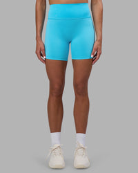 Woman wearing Fusion Ultra High-Rise 6" Short - Blue Atoll | Set:true | Angle:front | Model:Katie | Size:S