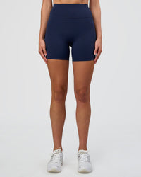 Woman wearing Fusion Ultra High-Rise 6" Short - Future Navy | Set:true | Angle:front | Model:Evie | Size:S