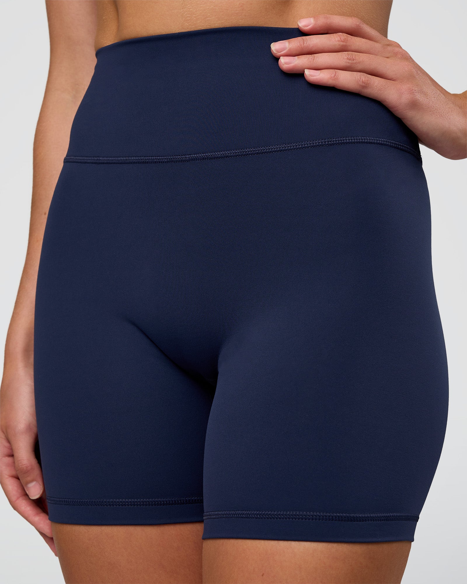 Woman wearing Fusion Ultra High-Rise 6" Short - Future Navy | Set:true | Angle:closeup | Model:Evie | Size:S
