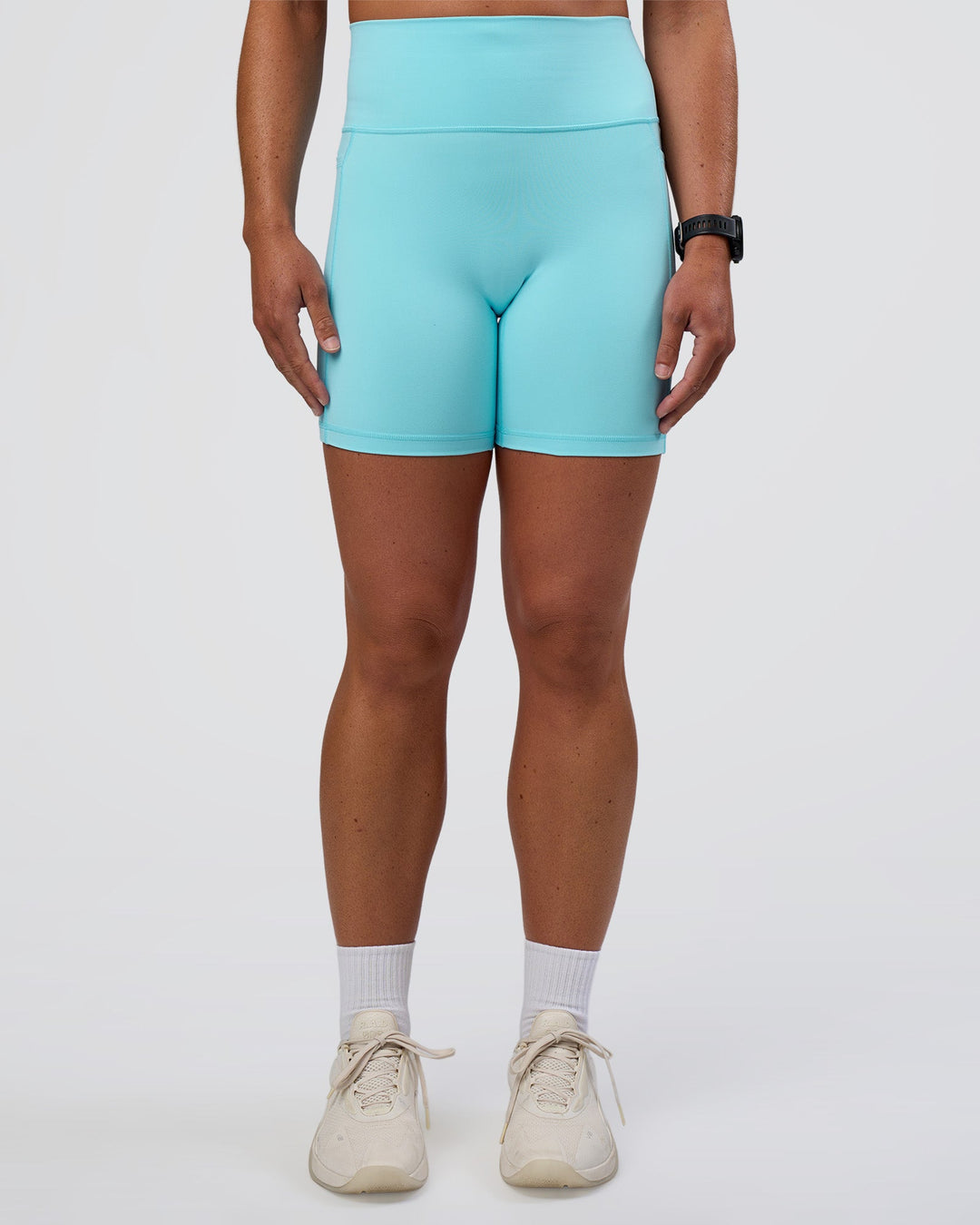 Woman wearing Fusion Ultra High-Rise 6&quot; Short Pockets - Baltic Sea | Model:Sav | Size:S