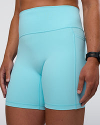 Woman wearing Fusion Ultra High-Rise 6" Short Pockets - Baltic Sea | Model:Sav | Size:S