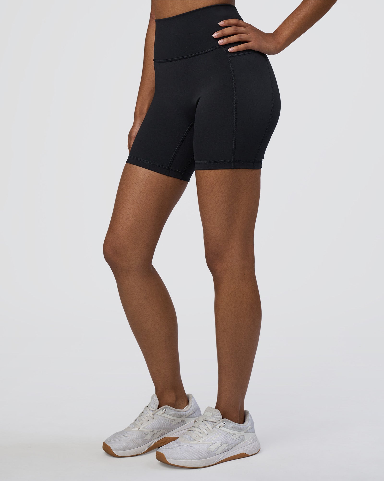 Woman wearing Fusion Ultra High-Rise 6" Short Pockets - Black | Model:Jordan | Size:S
