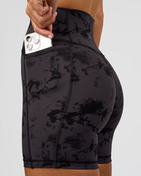 Woman wearing Fusion Ultra High-Rise 6" Short Pockets - Black Tie Dye | Set:true | Angle:closeup | Model:Amity | Size:S