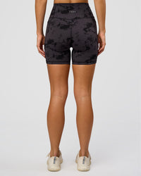 Woman wearing Fusion Ultra High-Rise 6" Short Pockets - Black Tie Dye | Set:true | Angle:back | Model:Amity | Size:S
