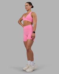 Woman wearing Fusion Ultra High-Rise 6" Short Pockets - Candy Pink | Model:Keisha | Size:S