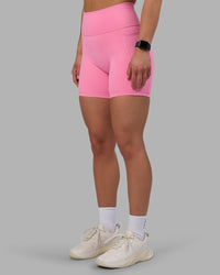 Woman wearing Fusion Ultra High-Rise 6" Short Pockets - Candy Pink | Set:true | Angle:side | Model:Keisha | Size:S