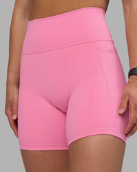 Woman wearing Fusion Ultra High-Rise 6" Short Pockets - Candy Pink | Model:Keisha | Size:S