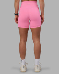 Woman wearing Fusion Ultra High-Rise 6" Short Pockets - Candy Pink | Set:true | Angle:back | Model:Keisha | Size:S