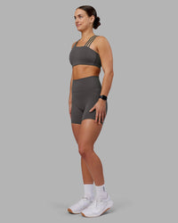 Woman wearing Fusion Ultra High-Rise 6" Short Pockets - Dark Storm | Model:Keisha | Size:S
