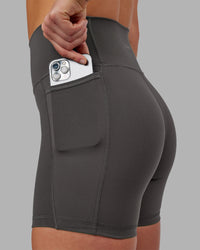 Woman wearing Fusion Ultra High-Rise 6" Short Pockets - Dark Storm | Set:true | Angle:closeup | Model:Keisha | Size:S