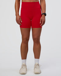 Woman wearing Fusion Ultra High-Rise 6" Short Pockets - Flame | Model:Sav | Size:S