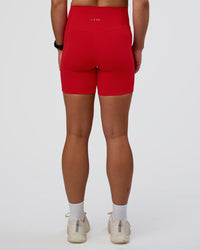 Woman wearing Fusion Ultra High-Rise 6" Short Pockets - Flame | Model:Sav | Size:S