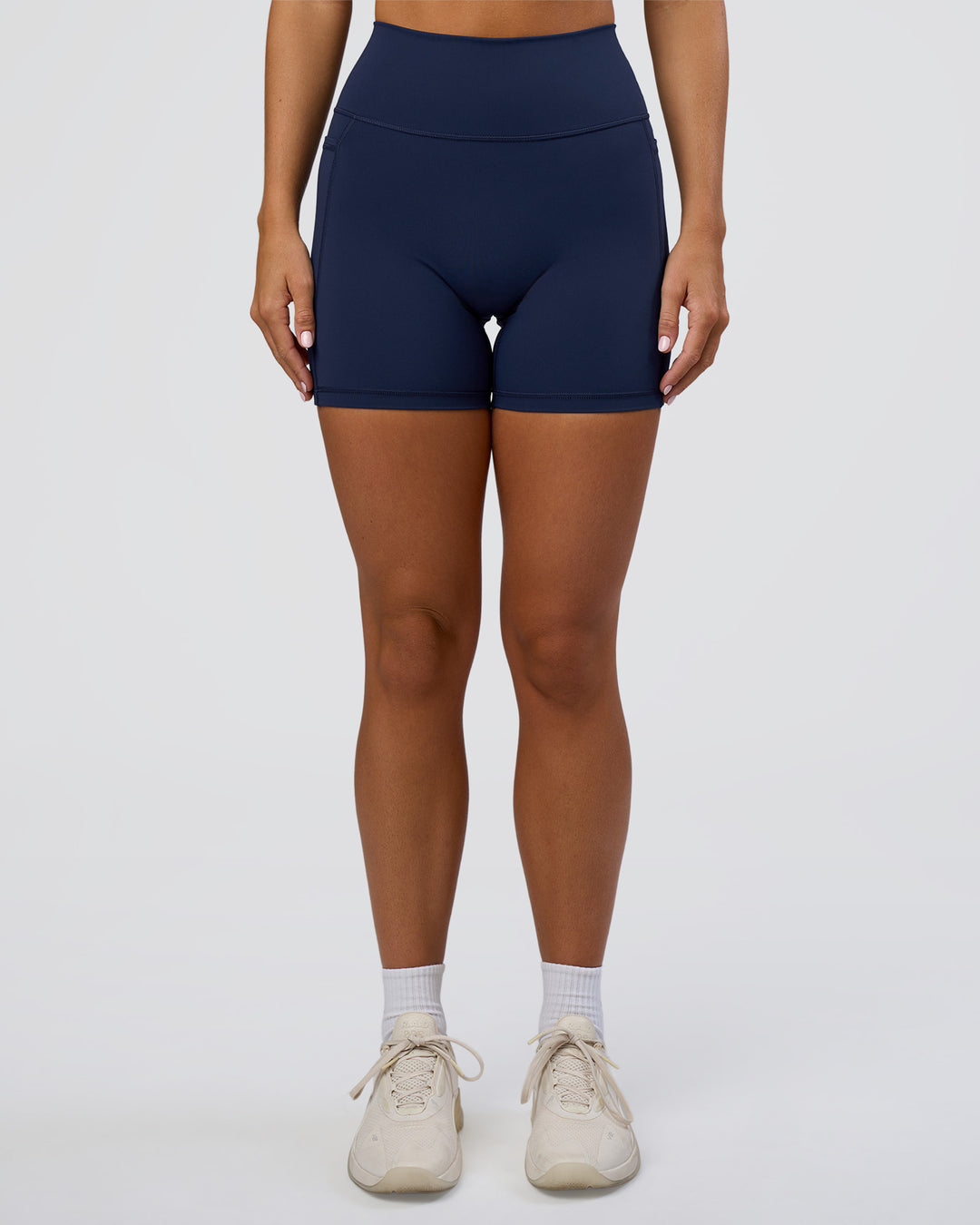 Woman wearing Fusion Ultra High-Rise 6" Short Pockets - Future Navy | Model:Amity | Size:S