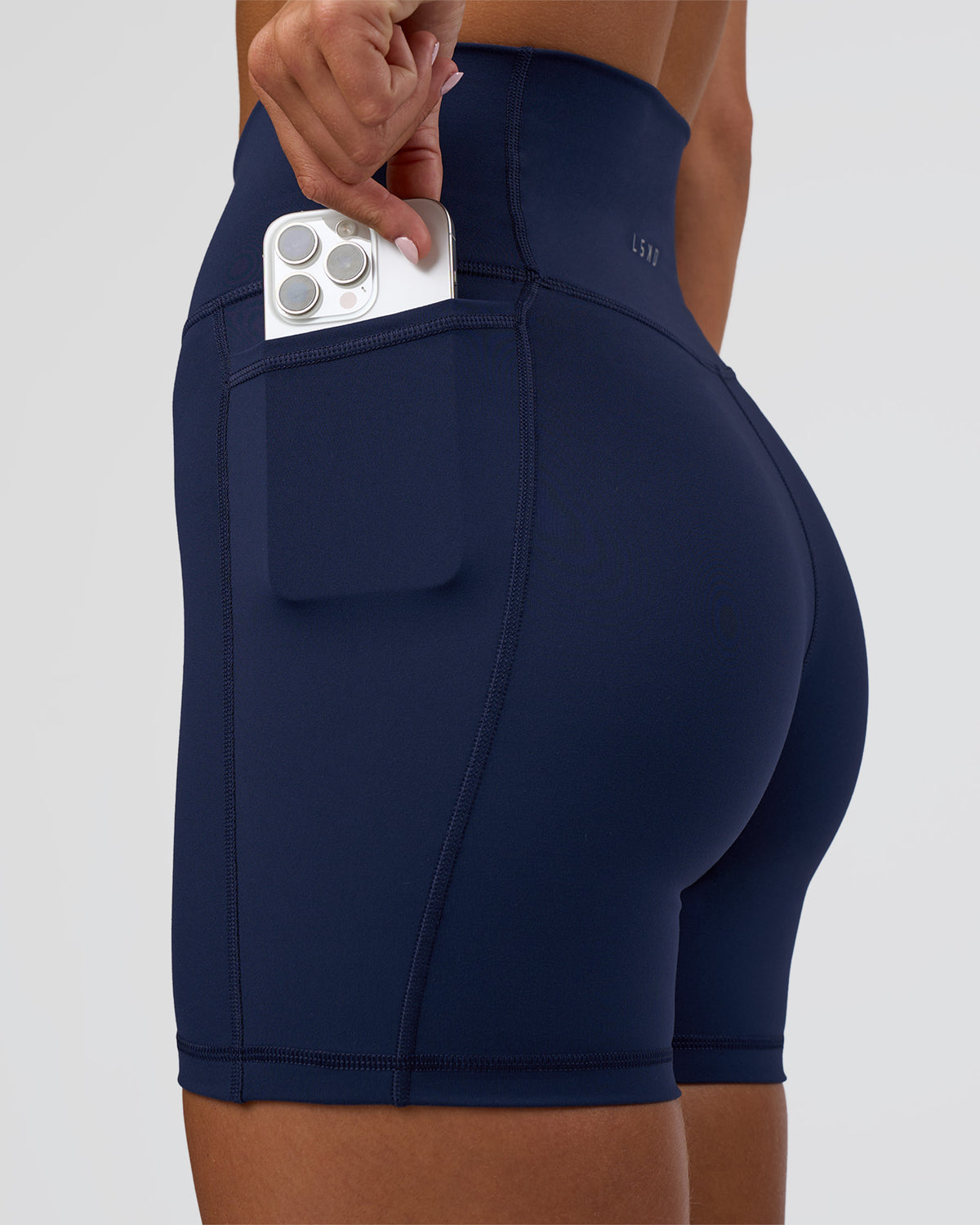Woman wearing Fusion Ultra High-Rise 6" Short Pockets - Future Navy | Set:true | Angle:closeup | Model:Amity | Size:S - view 1