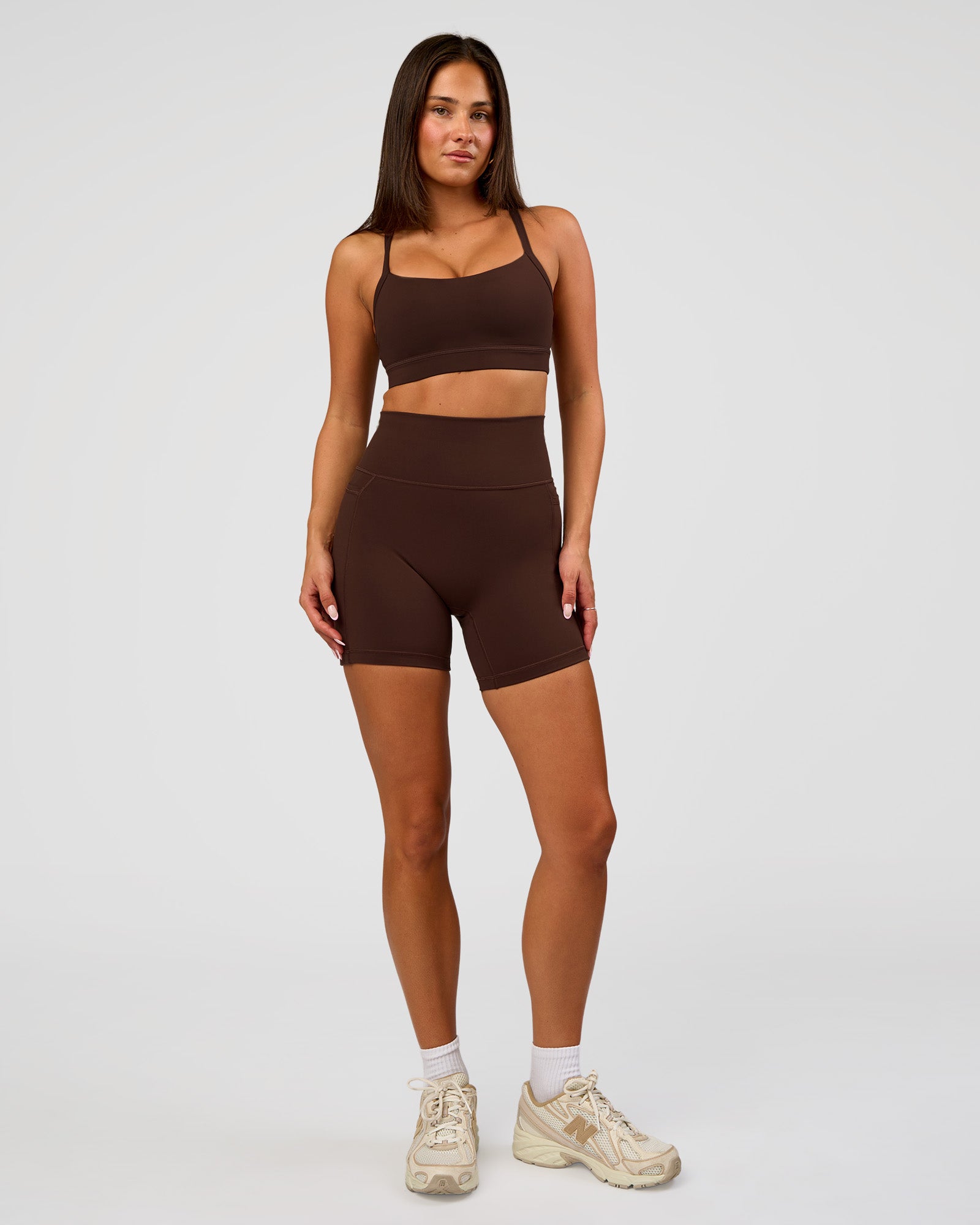 Woman wearing Fusion Ultra High-Rise 6" Short Pockets - Hot Chocolate | Model:Bianca | Size:S