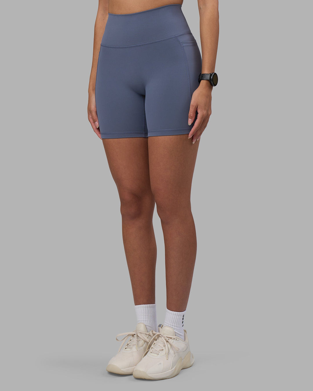 Woman wearing Fusion Ultra High-Rise 6&quot; Short Pockets - Night Shadow | Model:Rhiley | Size:S