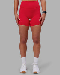 Woman wearing Fusion Ultra High-Rise 6" Short Pockets - Scarlet | Set:true | Angle:front | Model:Keisha | Size:S