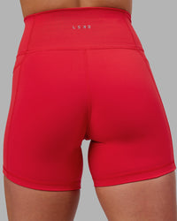 Woman wearing Fusion Ultra High-Rise 6" Short Pockets - Scarlet | Model:Keisha | Size:S