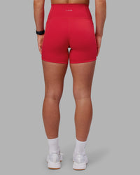 Woman wearing Fusion Ultra High-Rise 6" Short Pockets - Scarlet | Set:true | Angle:back | Model:Keisha | Size:S
