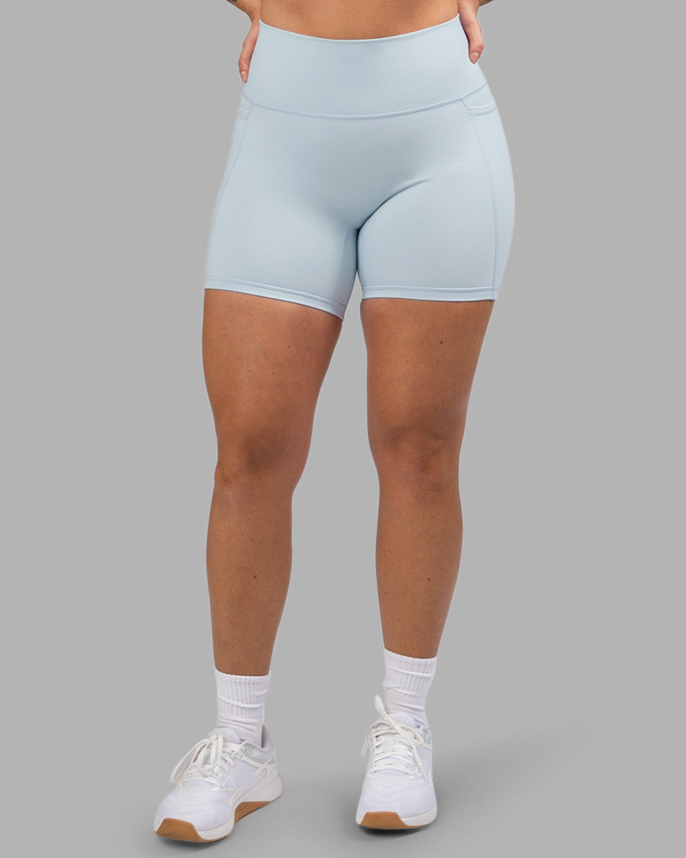 Woman wearing Fusion Ultra High-Rise 6" Short Pockets - Skyride| Set:true | Angle:front | Model:Robyn | Size:S
