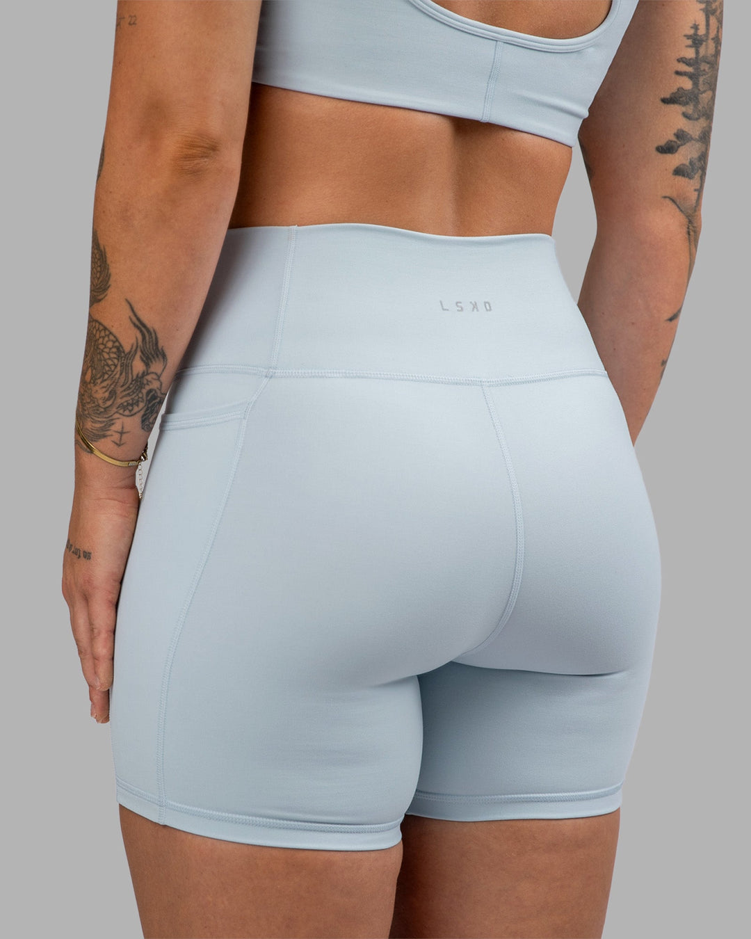 Woman wearing Fusion Ultra High-Rise 6" Short Pockets - Skyride| Model:Robyn | Size:S