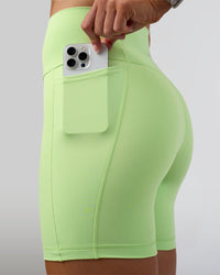 Woman wearing Fusion Ultra High-Rise 6" Short Pockets - Solar Lime | Set:true | Angle:closeup | Model:Emelia | Size:S