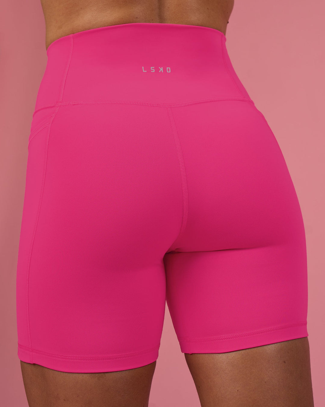 Woman wearing Fusion Ultra High-Rise 6" Short Pockets - Ultra Pink | Model:Hannah | Size:S