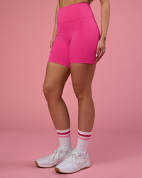 Woman wearing Fusion Ultra High-Rise 6" Short Pockets - Ultra Pink | Set:true | Angle:side | Model:Tianah | Size:S