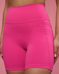 Woman wearing Fusion Ultra High-Rise 6" Short Pockets - Ultra Pink | Model:Hannah | Size:S