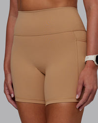 Woman wearing Fusion Ultra High-Rise 6" Short Pockets - Warm Smoke | Model:Phoebe | Size:S