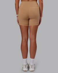 Woman wearing Fusion Ultra High-Rise 6" Short Pockets - Warm Smoke | Set:true | Angle:back | Model:Phoebe | Size:S