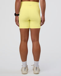 Woman wearing Fusion Ultra High-Rise 6" Short Pockets - Yellow Fizz | Set:true | Angle:back | Model:Sav | Size:S