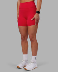 Woman wearing Fusion Ultra High-Rise 6" Short - Scarlet | Set:true | Angle:side | Model:Keisha | Size:S