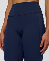 Woman wearing Fusion Ultra High-Rise 7/8 Legging Pockets - Future Navy | Model:Evie | Size:S