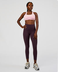 Woman wearing Fusion Ultra High-Rise 7/8 Legging Pockets - Midnight Plum | Model:Ellie | Size:S
