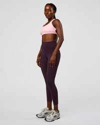 Woman wearing Fusion Ultra High-Rise 7/8 Legging Pockets - Midnight Plum | Model:Ellie | Size:S