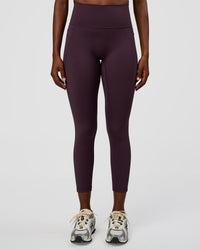 Woman wearing Fusion Ultra High-Rise 7/8 Legging Pockets - Midnight Plum | Model:Ellie | Size:S