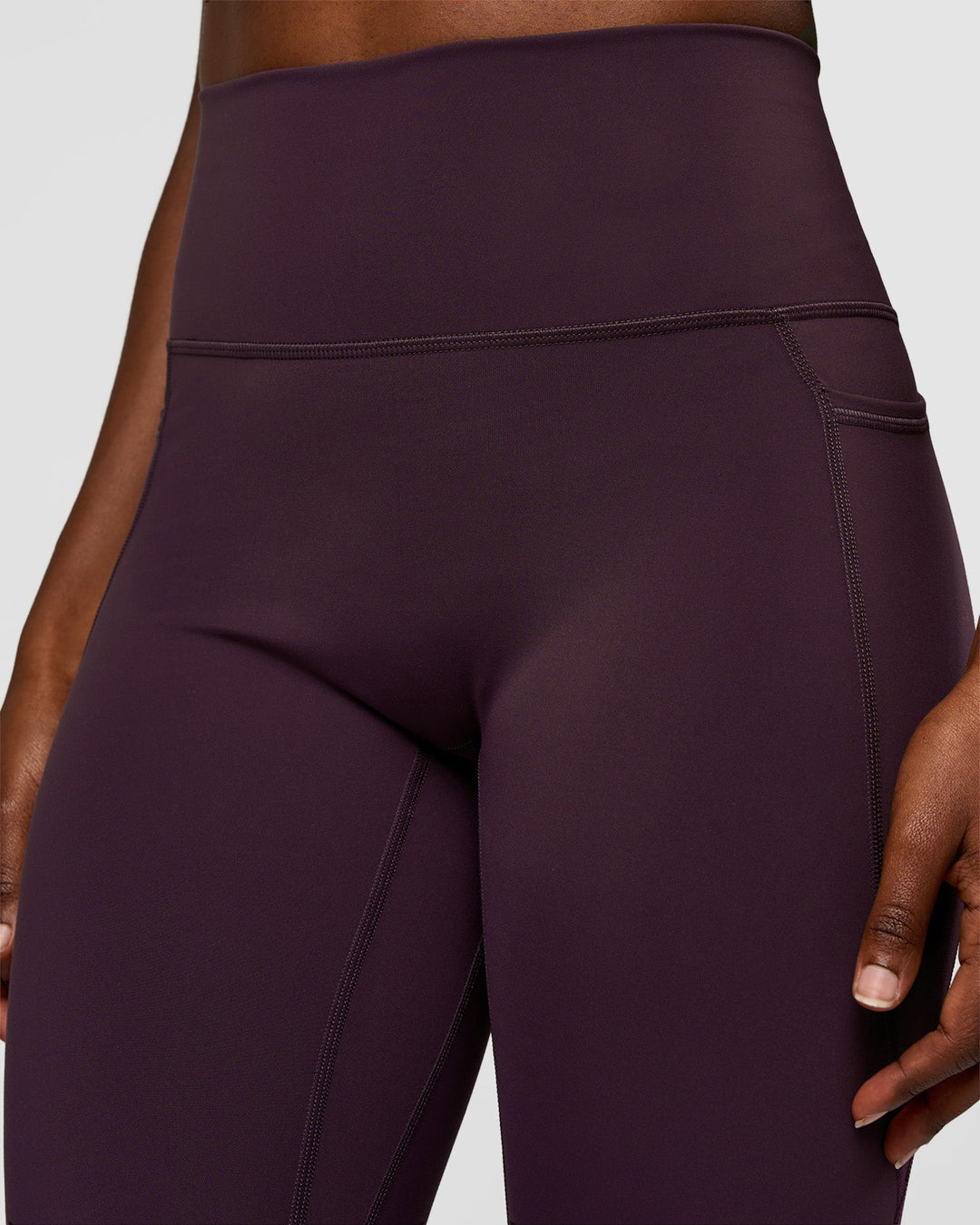 Woman wearing Fusion Ultra High-Rise 7/8 Legging Pockets - Midnight Plum | Model:Ellie | Size:S