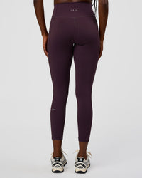 Woman wearing Fusion Ultra High-Rise 7/8 Legging Pockets - Midnight Plum | Model:Ellie | Size:S