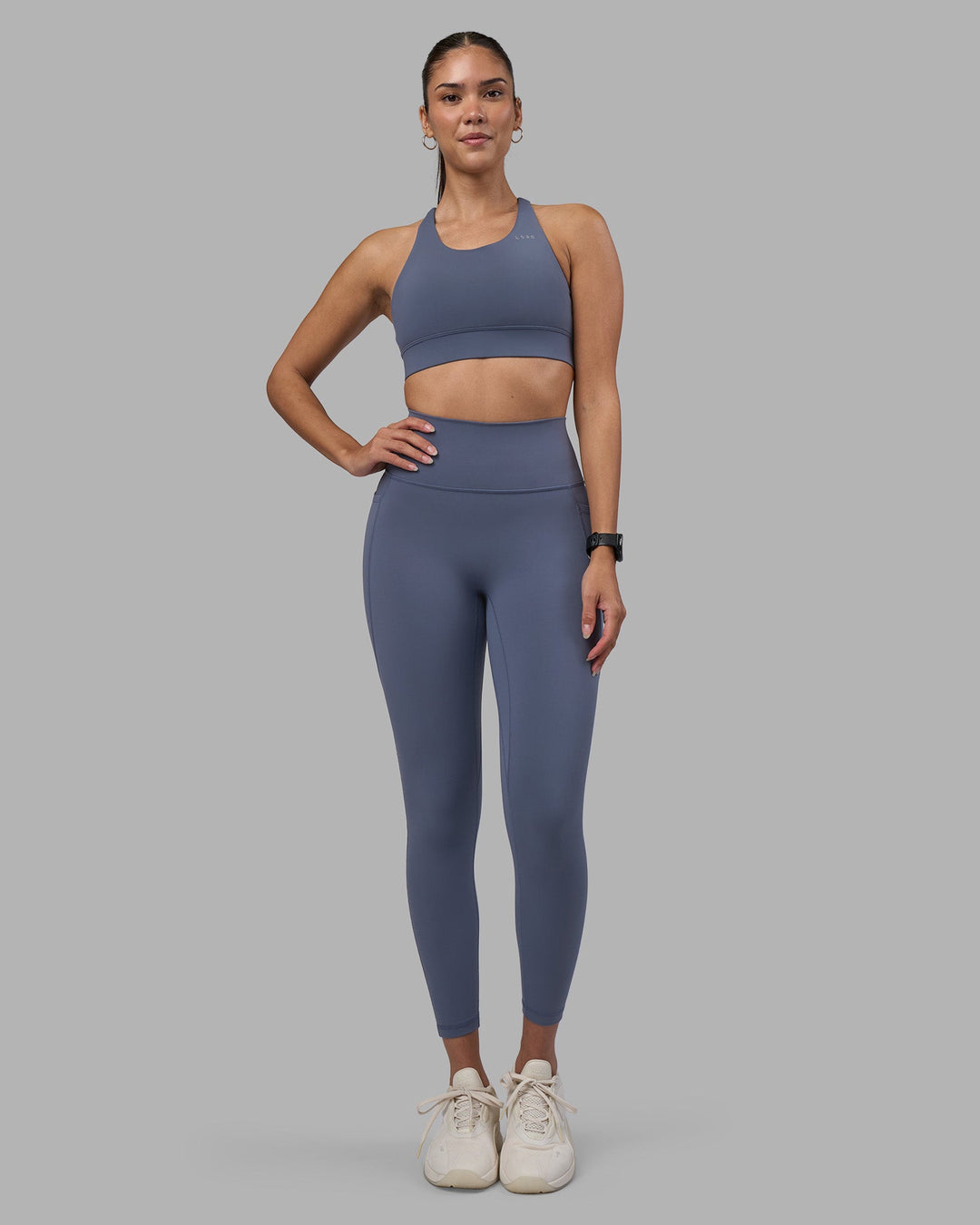 Woman wearing Fusion Ultra High-Rise 7/8 Legging Pockets - Night Shadow | Model:Rhiley | Size:S