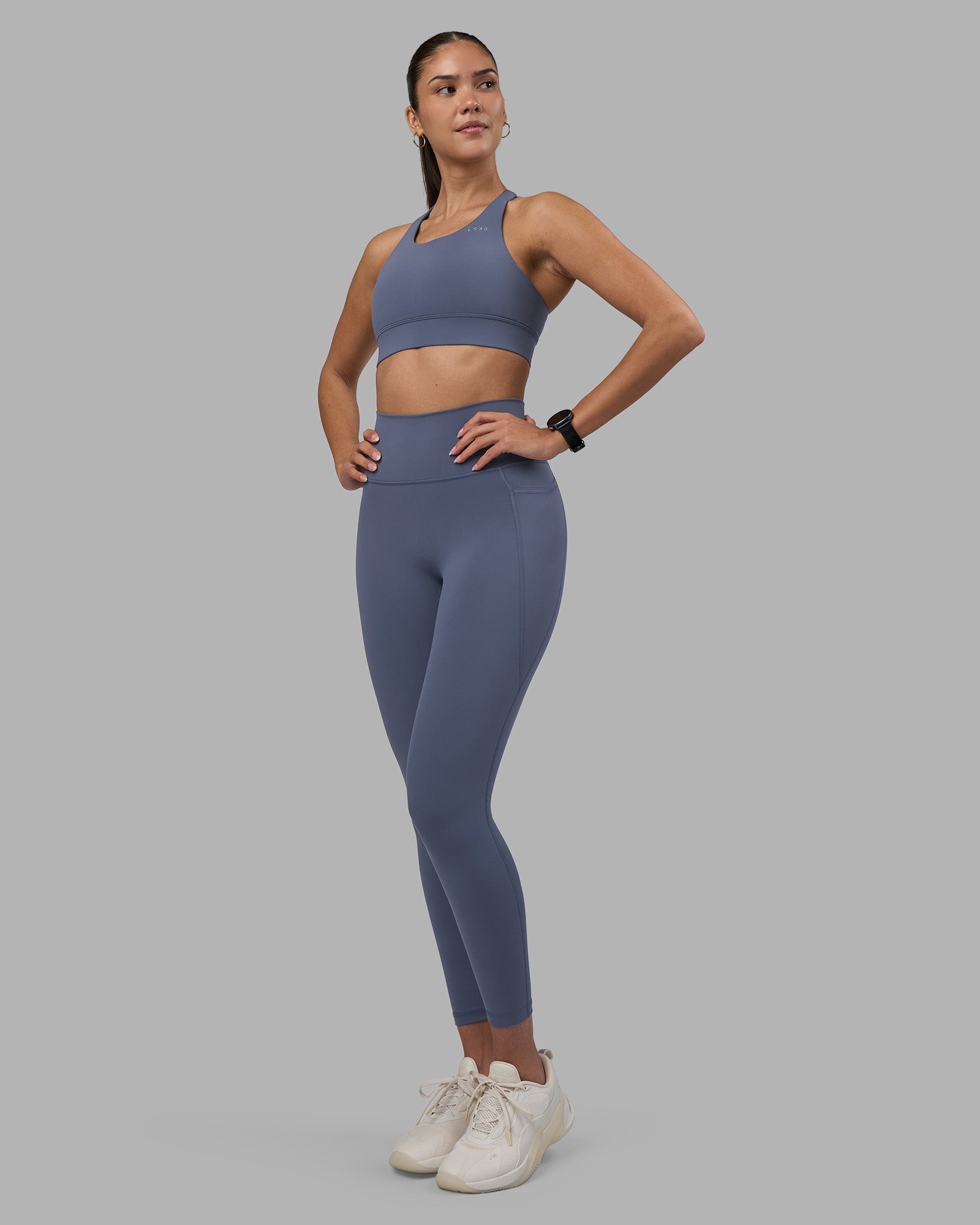 Woman wearing Fusion Ultra High-Rise 7/8 Legging Pockets - Night Shadow | Model:Rhiley | Size:S