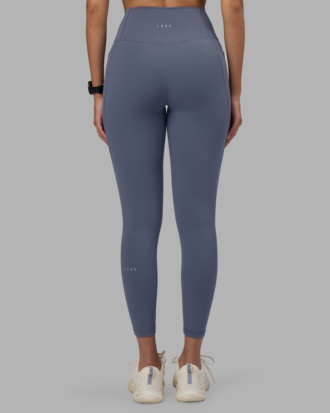 Woman wearing Fusion Ultra High-Rise 7/8 Legging Pockets - Night Shadow | Model:Rhiley | Size:S