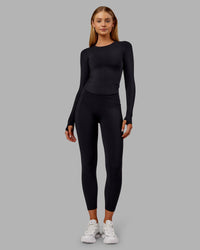 Woman wearing Fusion Ultra High-Rise 7/8 Thermal Legging Pockets - Black | Model:Ella | Size:S