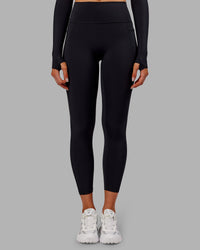 Woman wearing Fusion Ultra High-Rise 7/8 Thermal Legging Pockets - Black | Model:Ella | Size:S