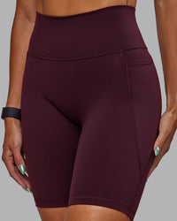Woman wearing Fusion Ultra High-Rise 9" Short Pockets - Cherry Lacquer | Model:Vanessa | Size:S